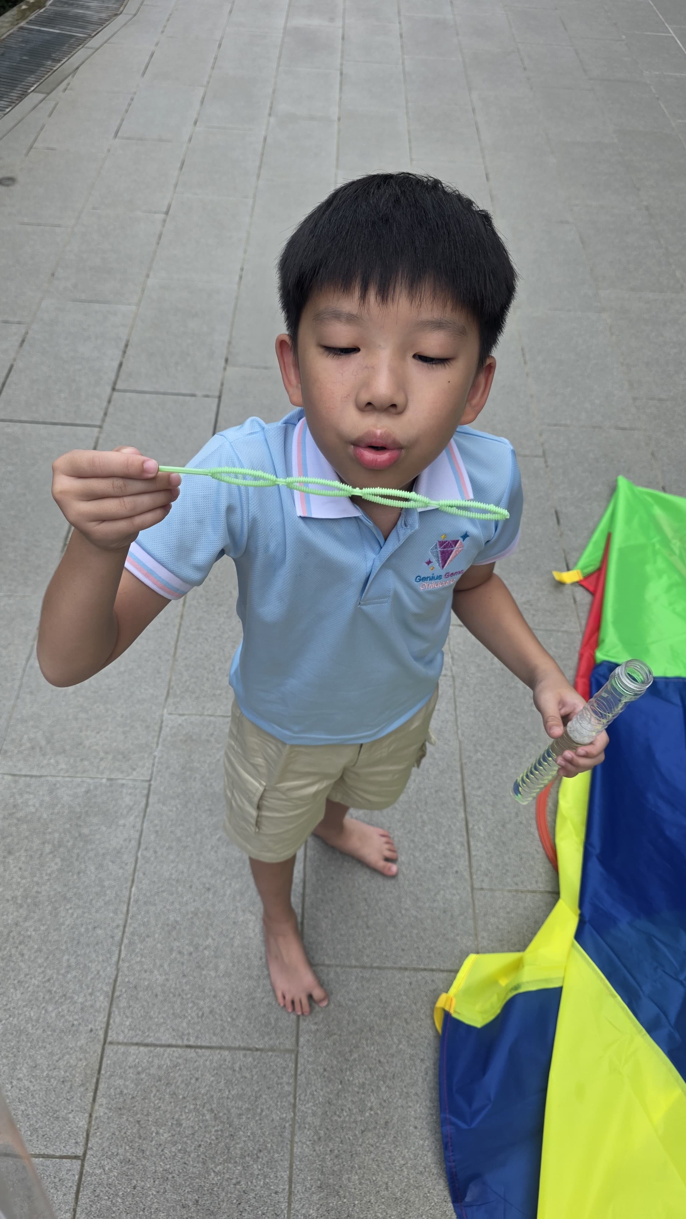 Child joyfully playing with bubbles at Genius Gems Childcare Centre in Changi